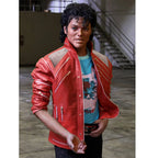 Person wearing a red jacket with zippers, standing indoors.
