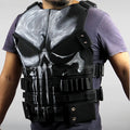 Person wearing a tactical vest with a skull design on a plain background