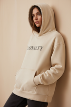 Female model wearing Loyalty sand Premium Logo Hoodie
